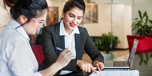 Bank worker assisting customer with check